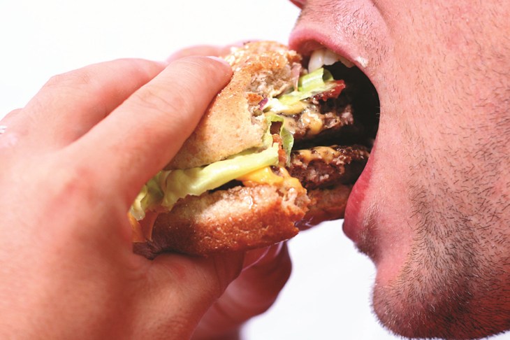 Man eating burger 1772x1180.jpg