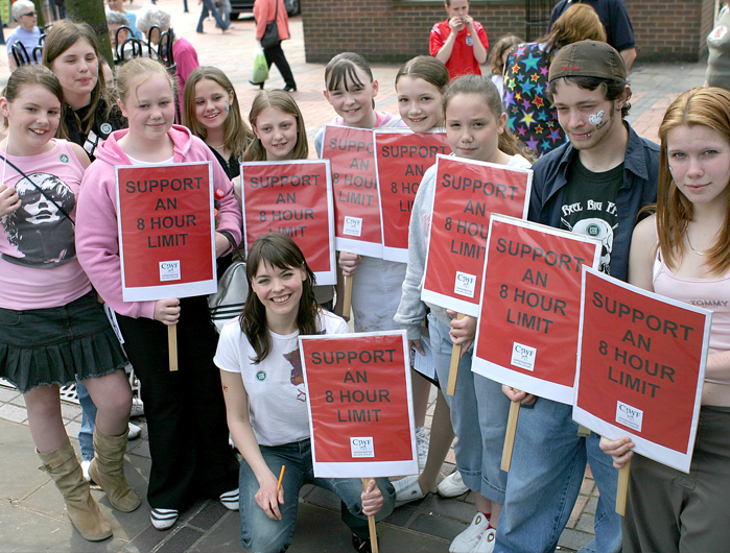 Kate Ford with children holding signs