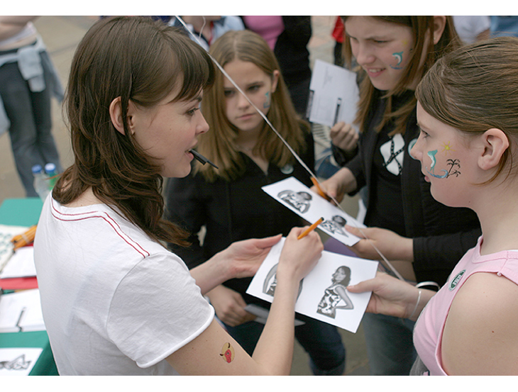 Kate ford in a crowd signing form at demo