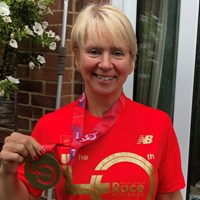 Jo Bell fundraiser holding a medal